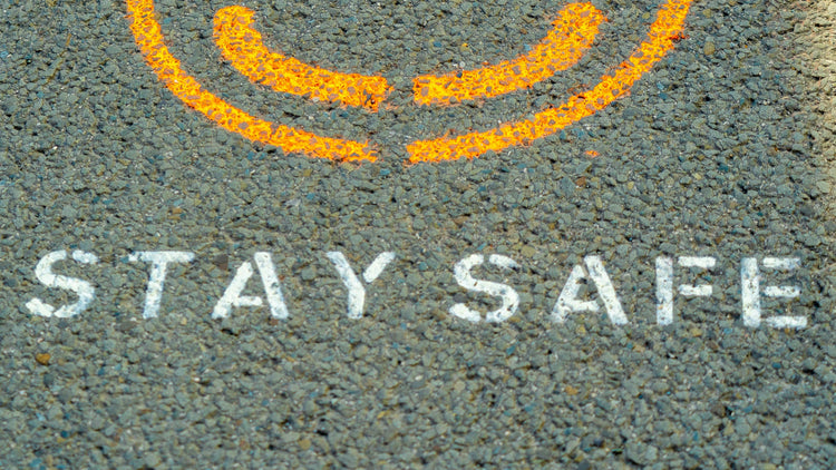 A printed text of stay safe on a road