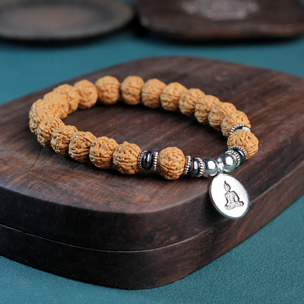 Rudraksha bracelet featuring a silver Buddha pendant, enhancing spiritual practice and focus