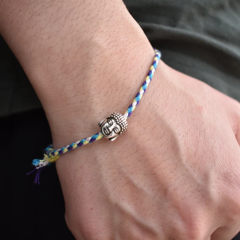 Adjustable length, multicolored woven bracelet with a serene Buddha head accent