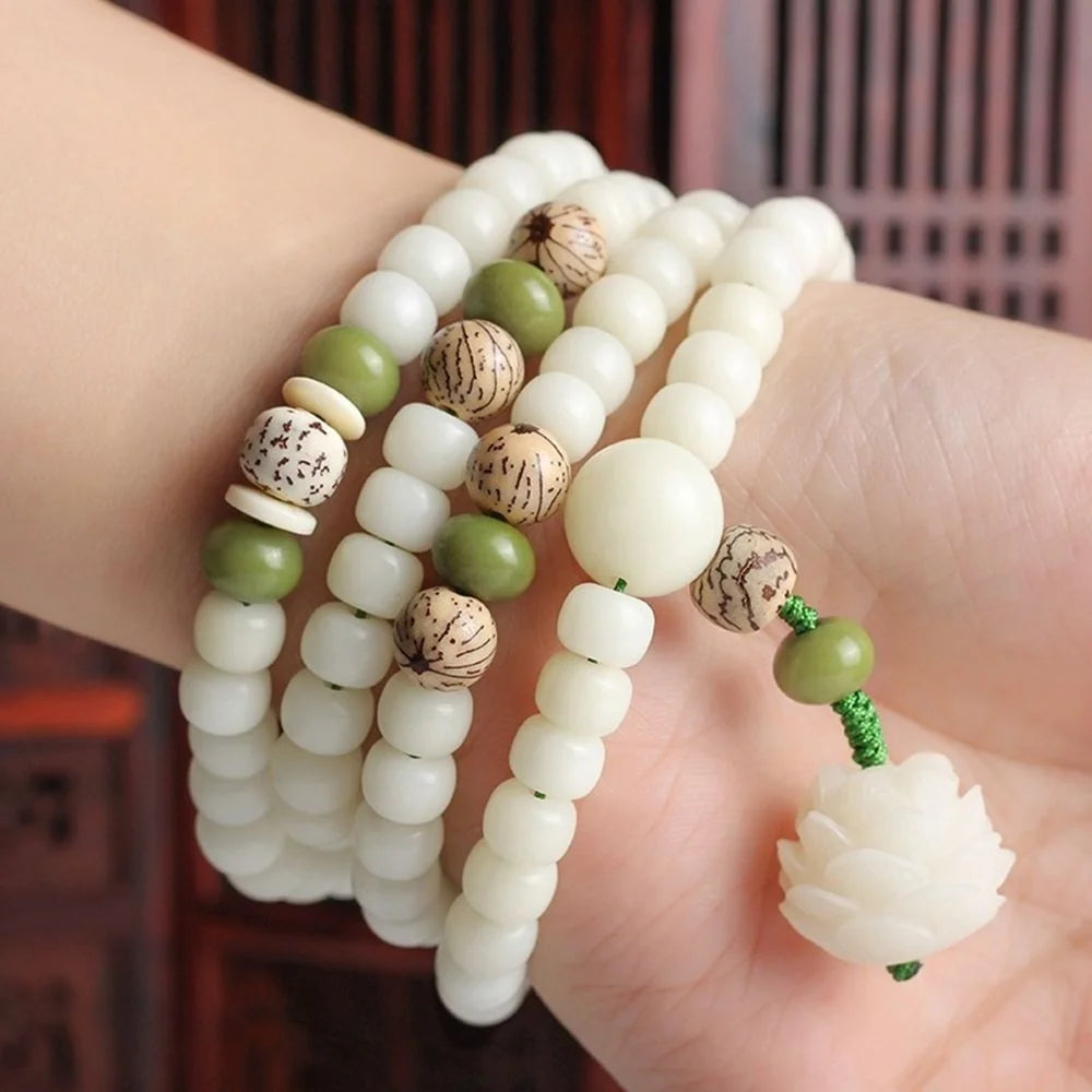 Delicate white bodhi seed root jewelry piece on a woman's wrist