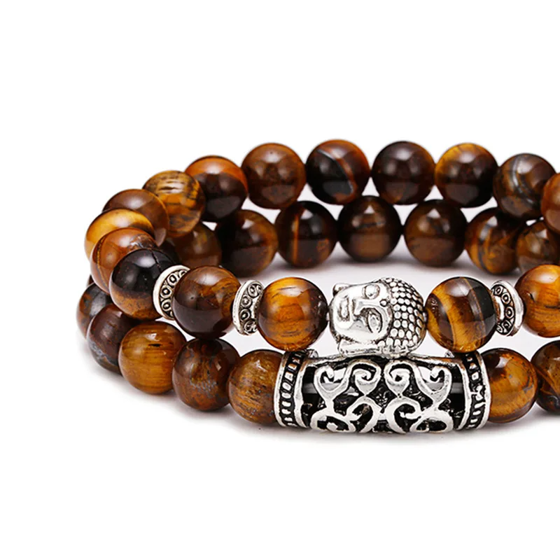 Close-up view of the tiger's eye bead bracelet, showcasing the silver Buddha charm and unique bead patterns