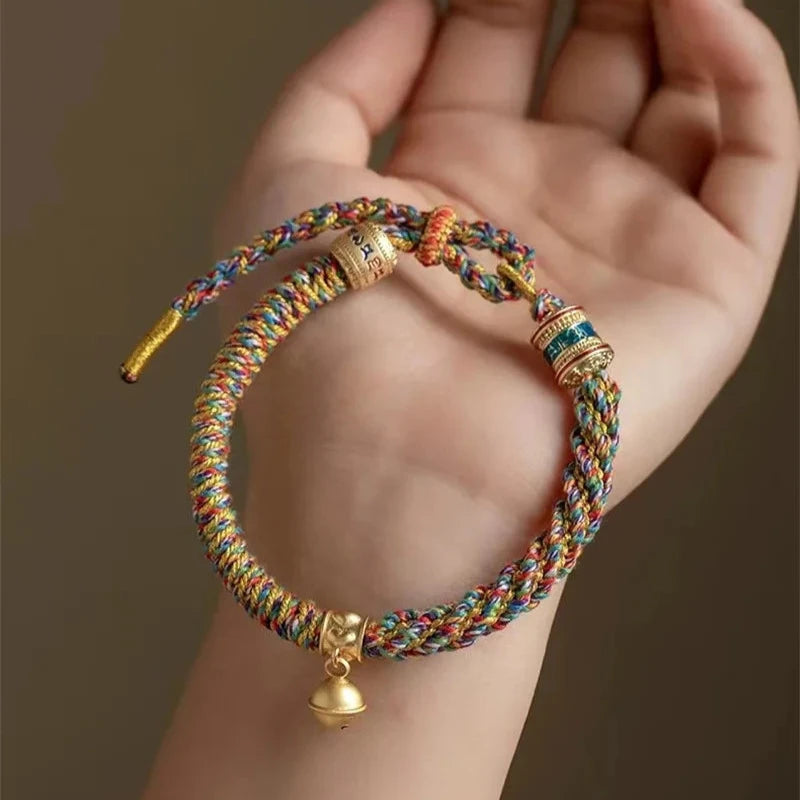 Multicolored Tibetan Lucky Hand-woven Rope Bracelet displayed on palm showing intricate weaving pattern