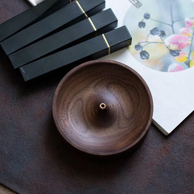 Artisan-made incense holder placed beside tea set for calm ritual