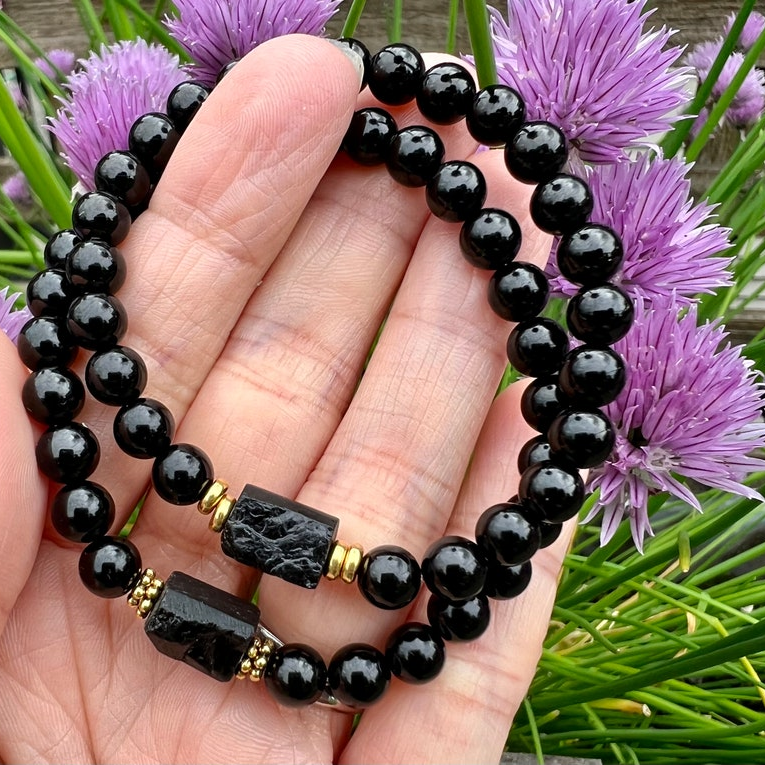 Black tourmaline bracelet in natural light highlighting deep black tone and gold spacer accents