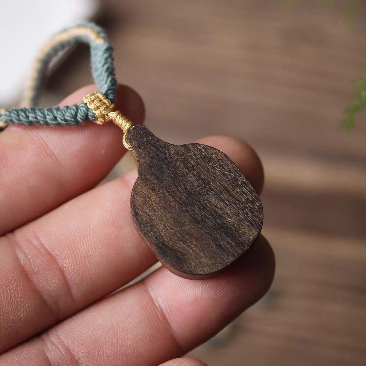 Back view of Zashi Lhamo wood carved Buddha amulet pendant
