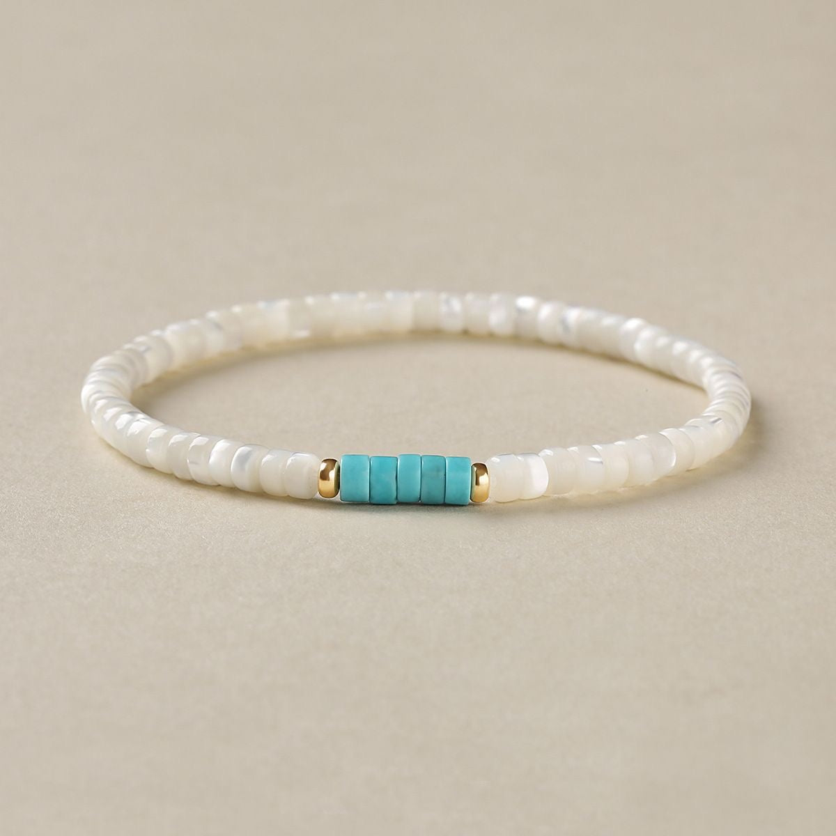 White shell bracelet with turquoise spacer bead front view