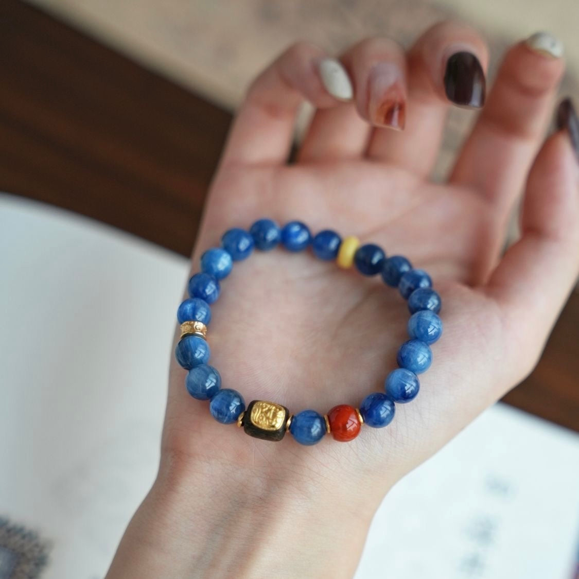 Luxury beaded bracelet crafted from kyanite, red agate, and agarwood wood beads.