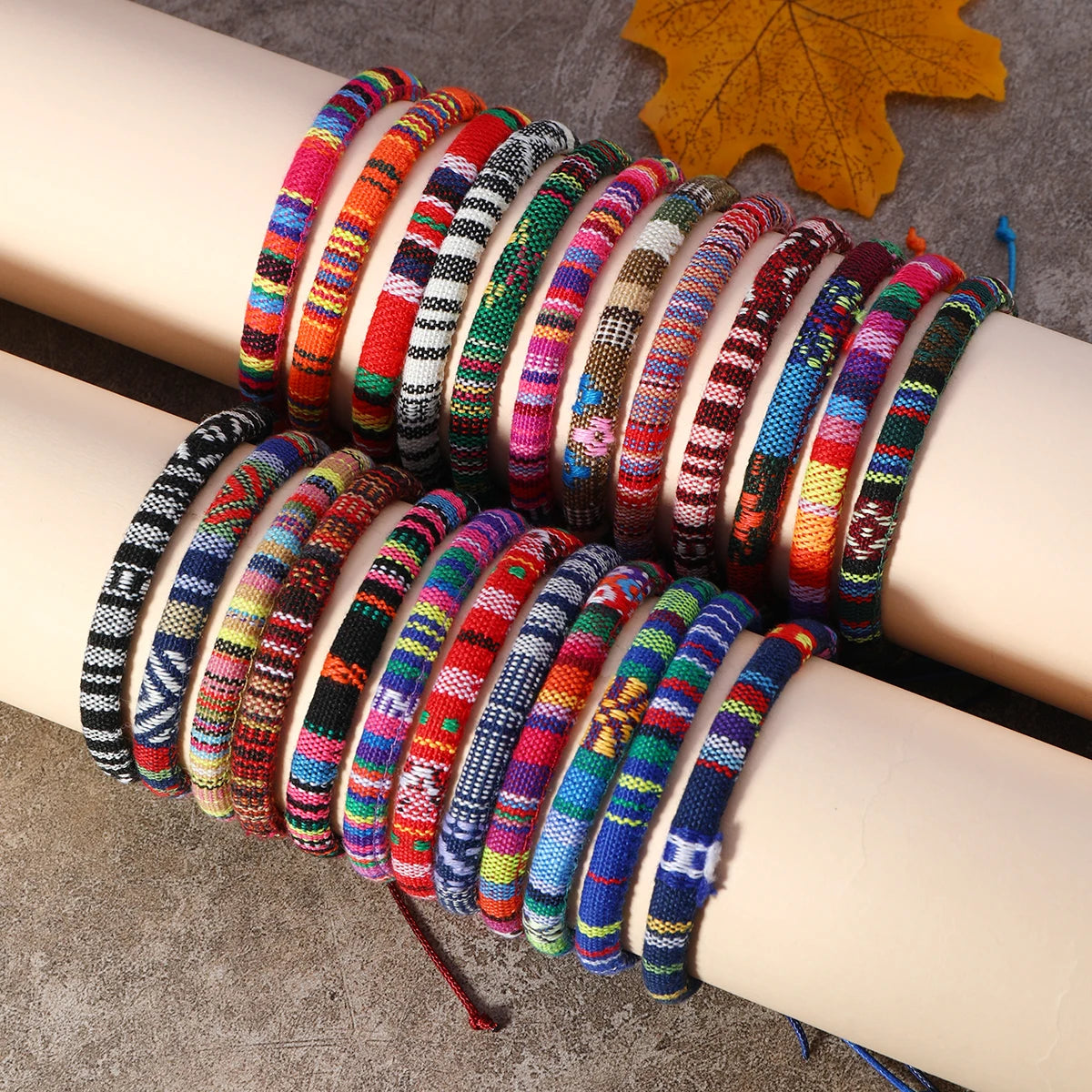 Close-up detail of handmade woven stack bracelets with bright yarn