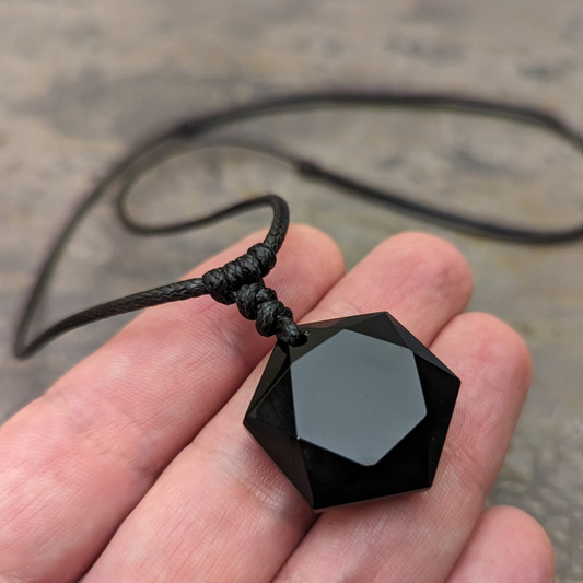 obsidian necklace hold in hand