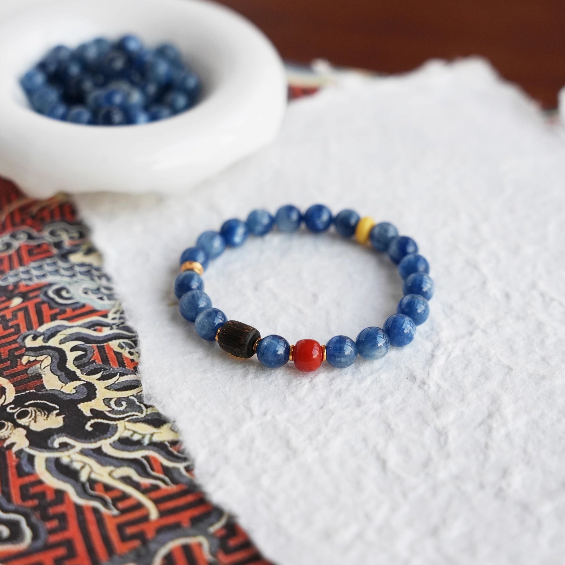Ocean’s Gaze bracelet made of kyanite, red agate, and agarwood – front view