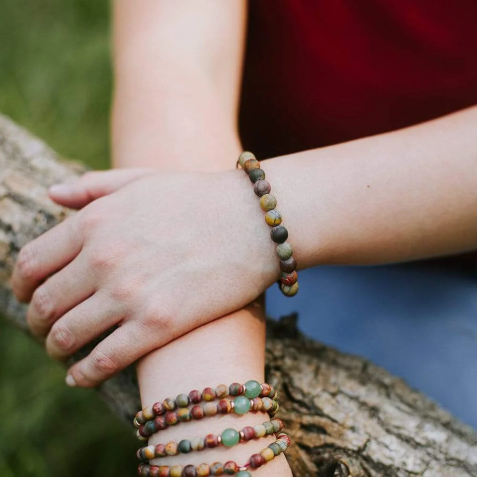 Woman wearing riverstone mala bracelet outdoors 