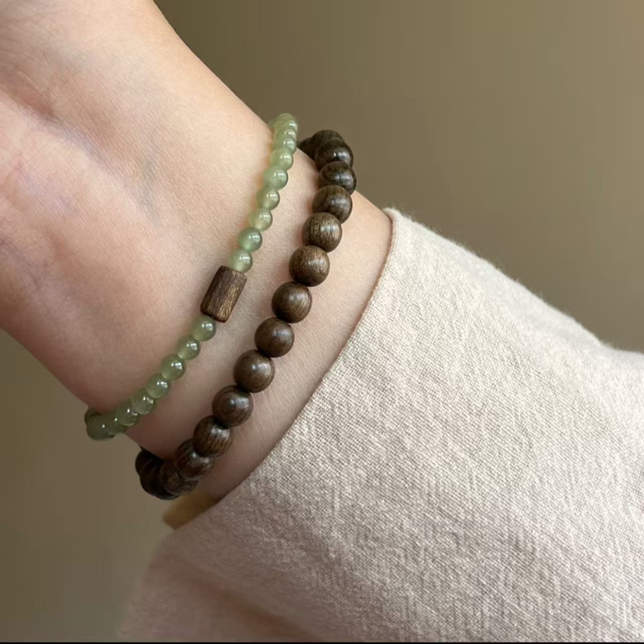 Layered styling of sandalwood and nephrite jade bracelets