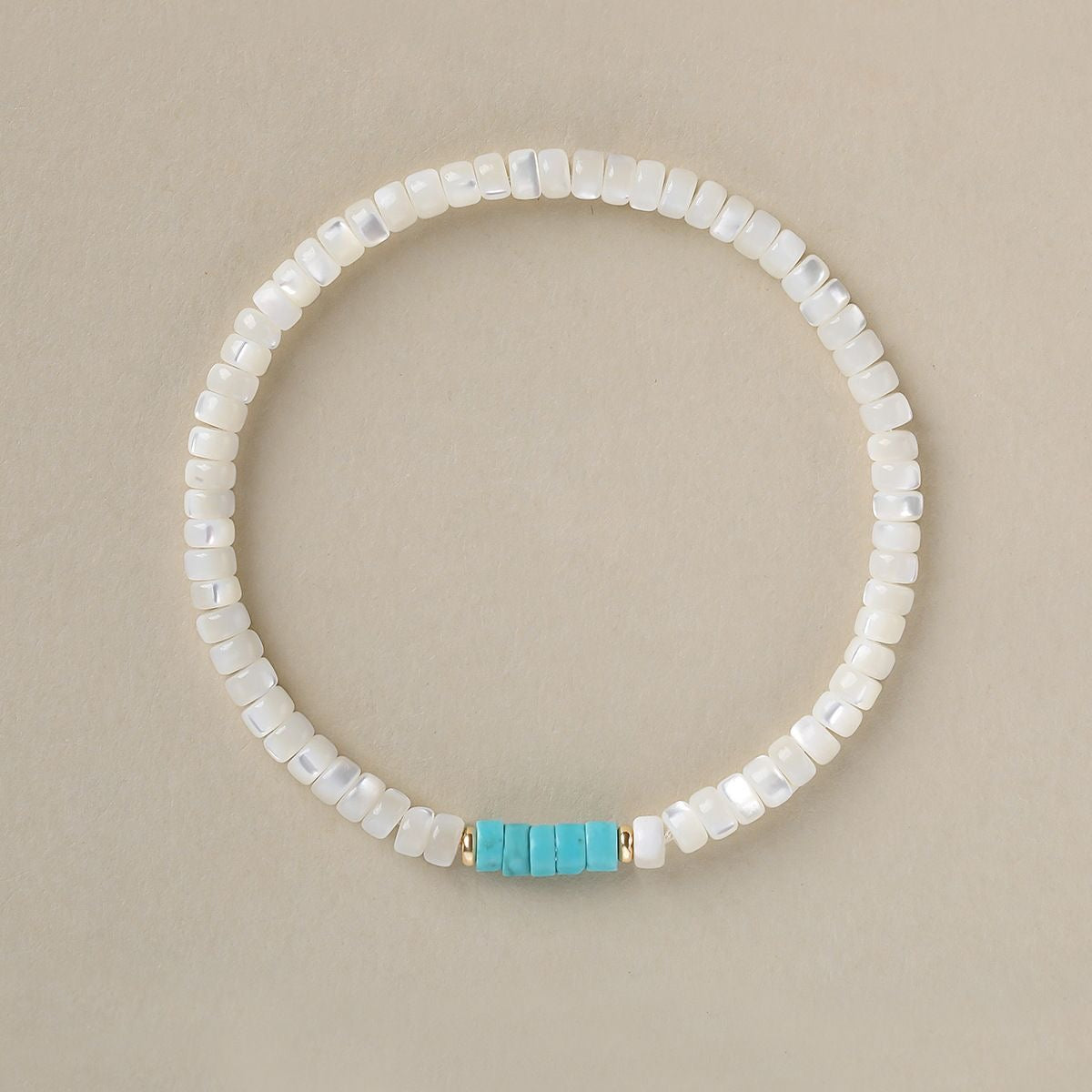 Handmade boho bracelet with white shell beads and turquoise spacer