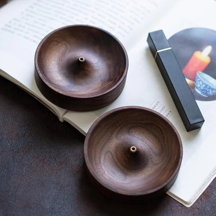 Wooden incense holder on minimalist Zen desk setup