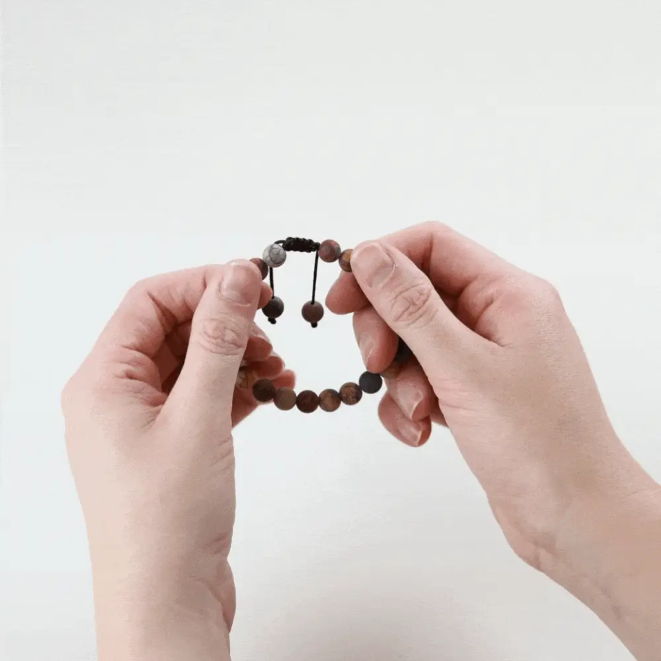 Matte riverstone wrist mala bracelet on white background
